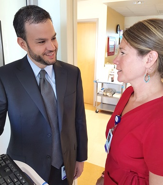 Kyle Staller, MD, consults with Katie Matthews, RN.