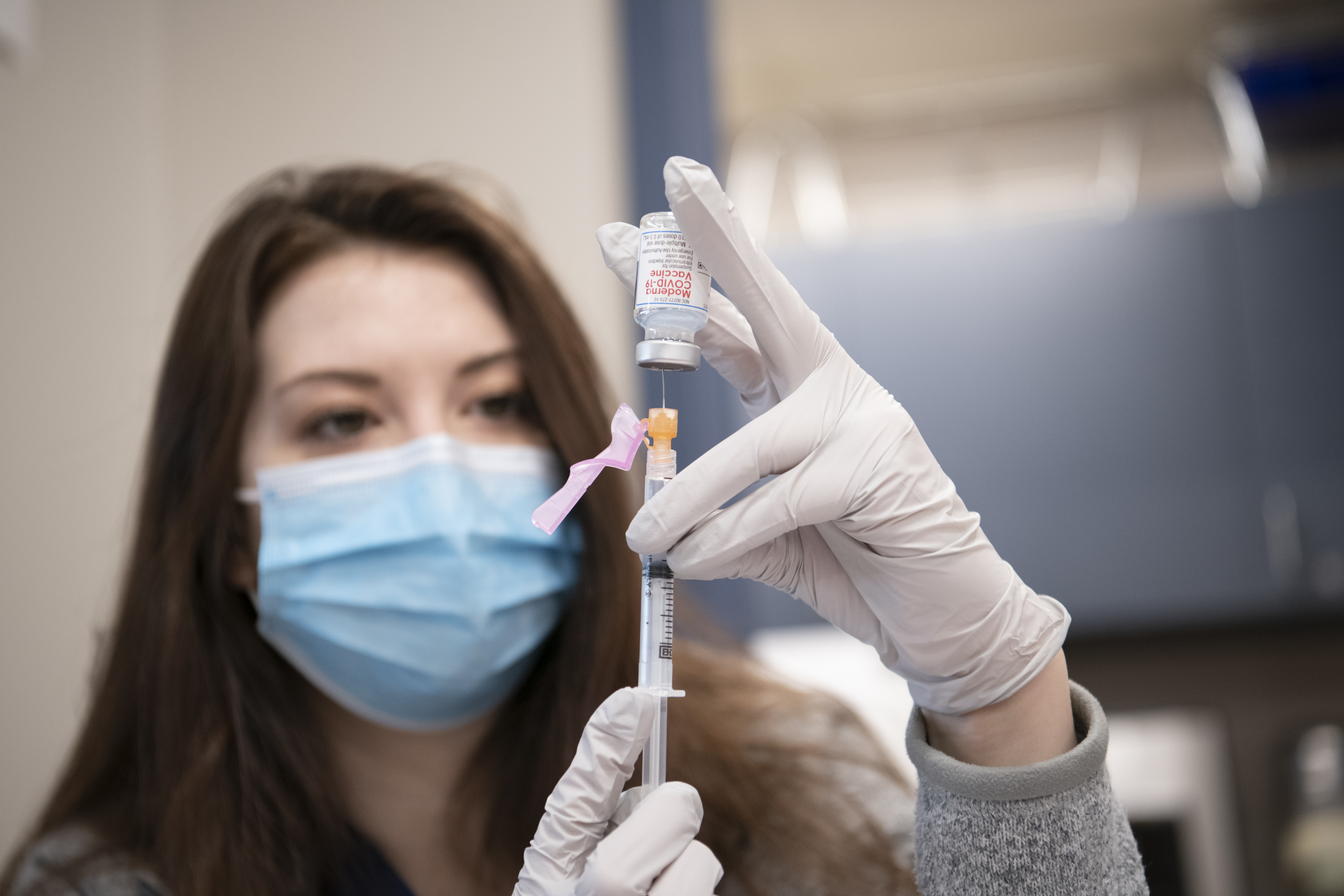 medical professional preparing vaccine shot