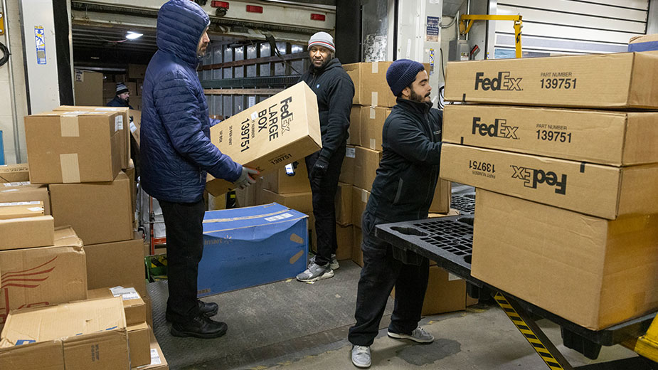 Workers load boxes in the loading dock