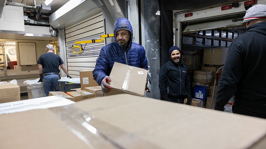 Workers load boxes in the loading dock