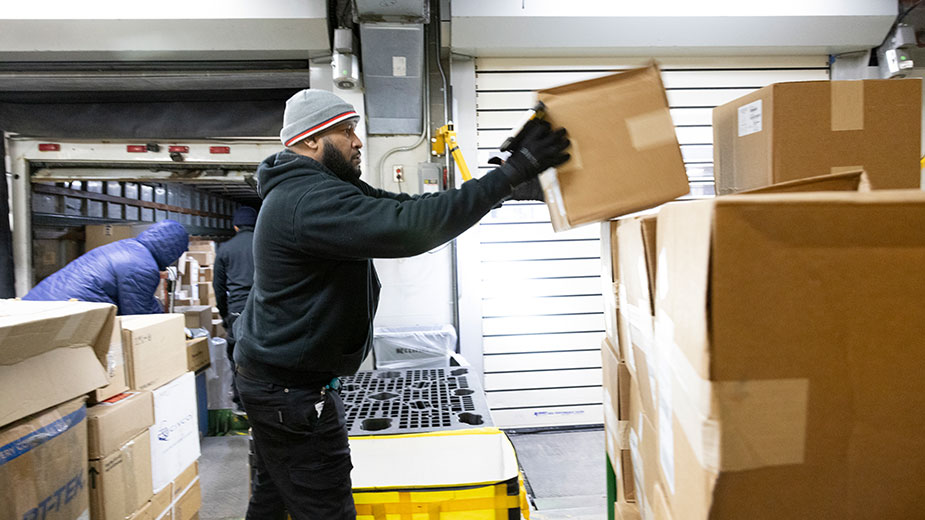 Workers load boxes in the loading dock