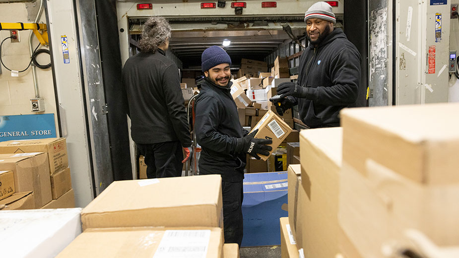 Workers load boxes in the loading dock