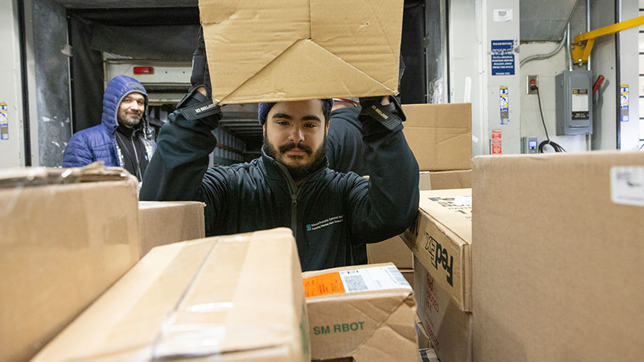 Workers load boxes in the loading dock