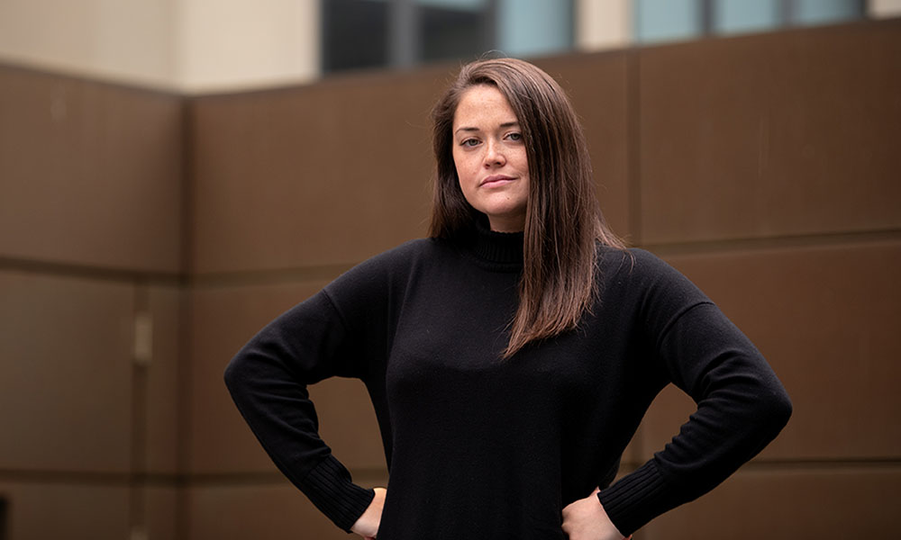 Erin Morrissey, a Mass General patient with adrenocortical carcinoma, a rare form of cancer, stands with her hands on her hips.