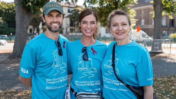 Tess (center) with her husband and Mass General Brigham oncologist, Diana Cirstea, MD