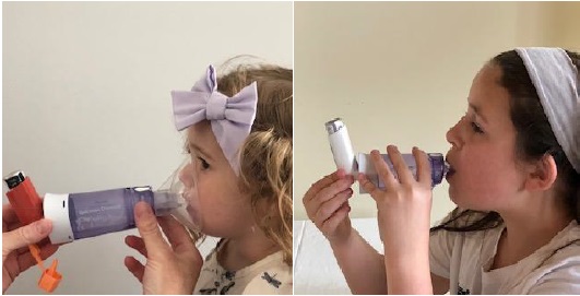 Two children demonstrating how to use an inhaler with a spacer and a mask.