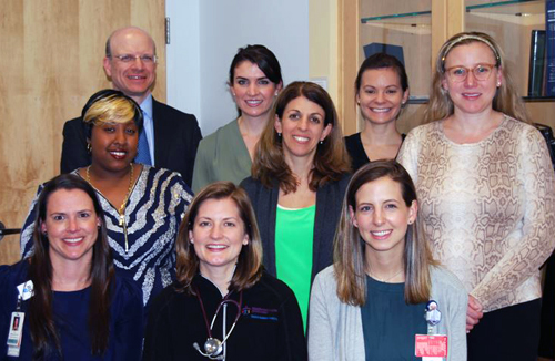 Nine members of the Pediatric Nutrition Team pose in an office.