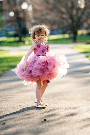 Rowan Lambert wears a pink, sparkly tutu with ruffles while dancing on her driveway.