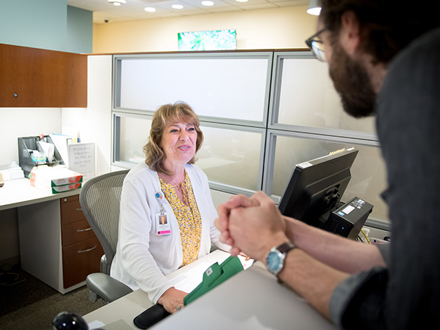 A care coordinator checks in a patient