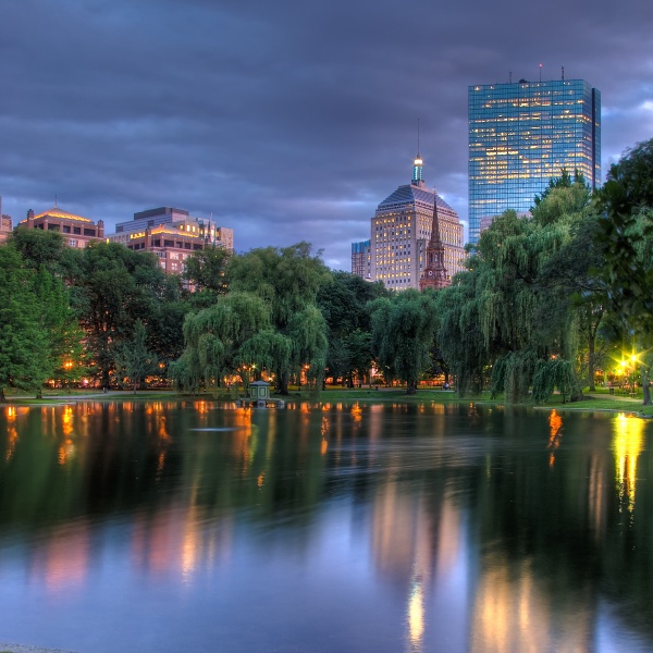 The Boston skyline, with a park and pond in the foreground.