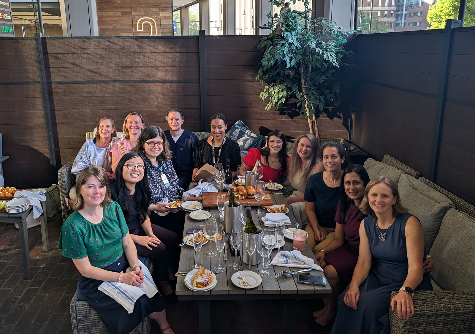 People crowded around a table at a chic restaurant.