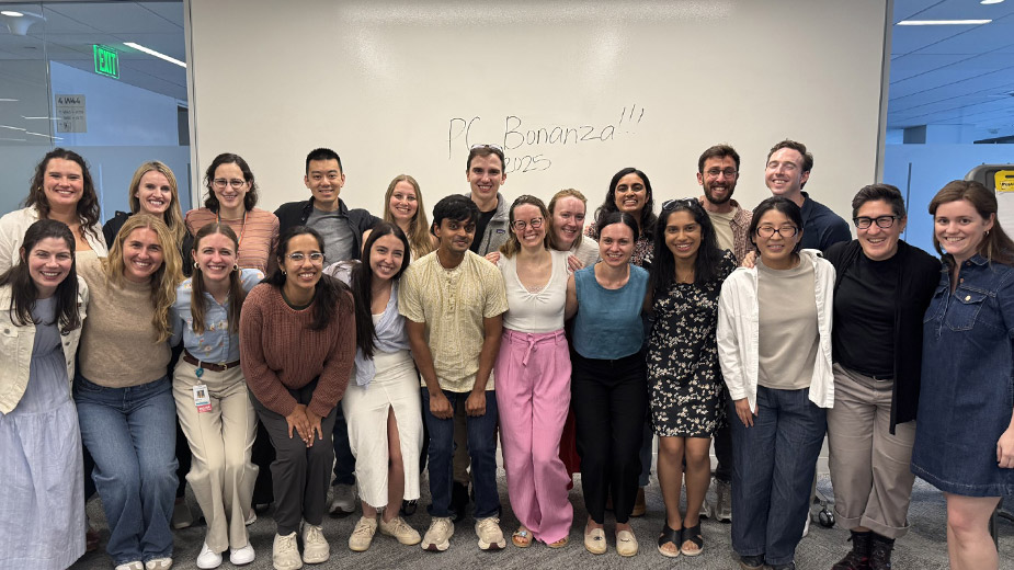 A group photo of people smiling together indoors