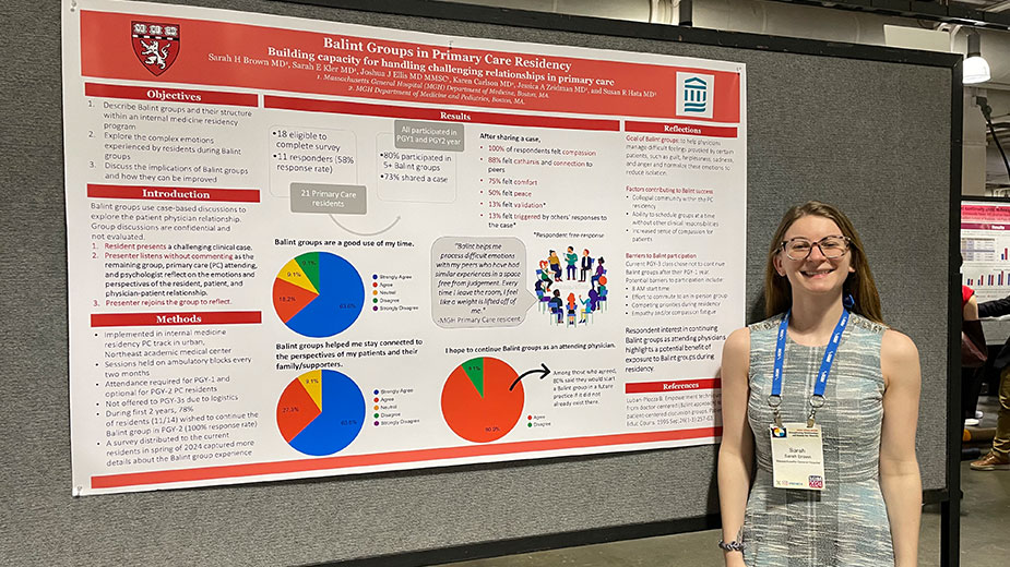 A hospital resident standing next to a poster board