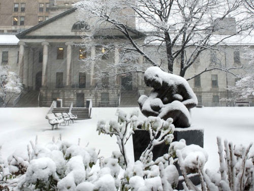 Care sculpture in front of the historic Bulfinch building on a snowy day