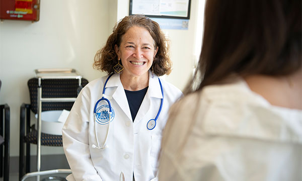 Merit Cudkowicz, MD, MSc, with a patient