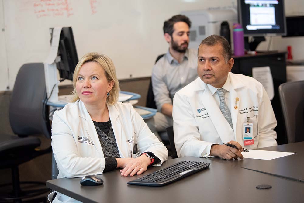 Dr.'s Singhal and Rost confer about a stroke case Dr.'s Singhal and Rost confer about a stroke case