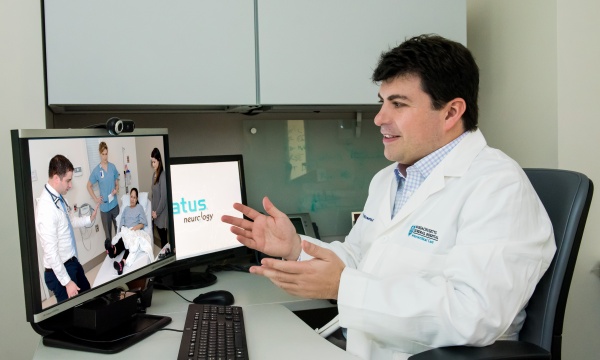 Eric Rosenthal, MD, consults a patient by videoconference