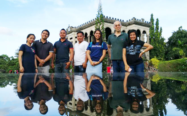 Group photo of team members in front of a fountain