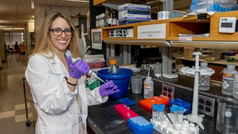 Women in a lab coat doing research Women in a lab coat doing research