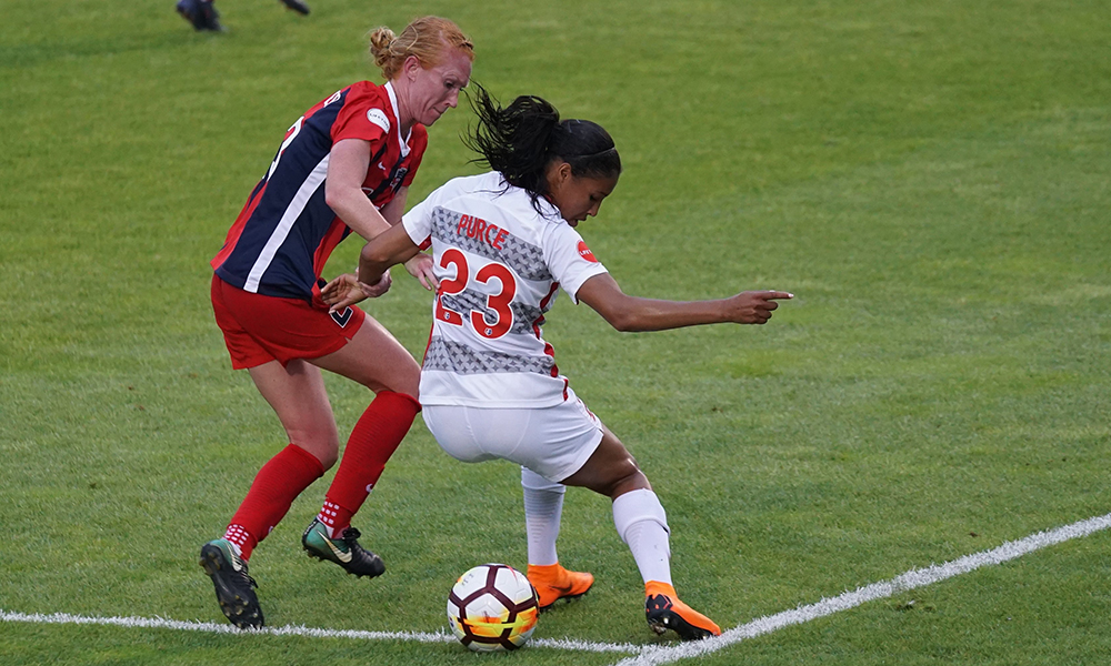two women playing soccer