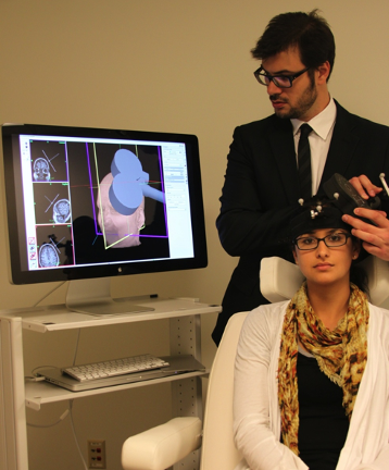 Transcranial magnetic stimulation being used on a patient.