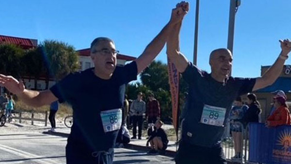 Two older men running in a marathon