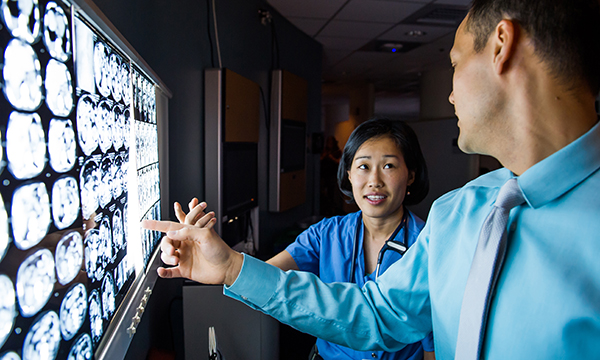 Physicians discussing patient image results. Physicians discussing patient image results.