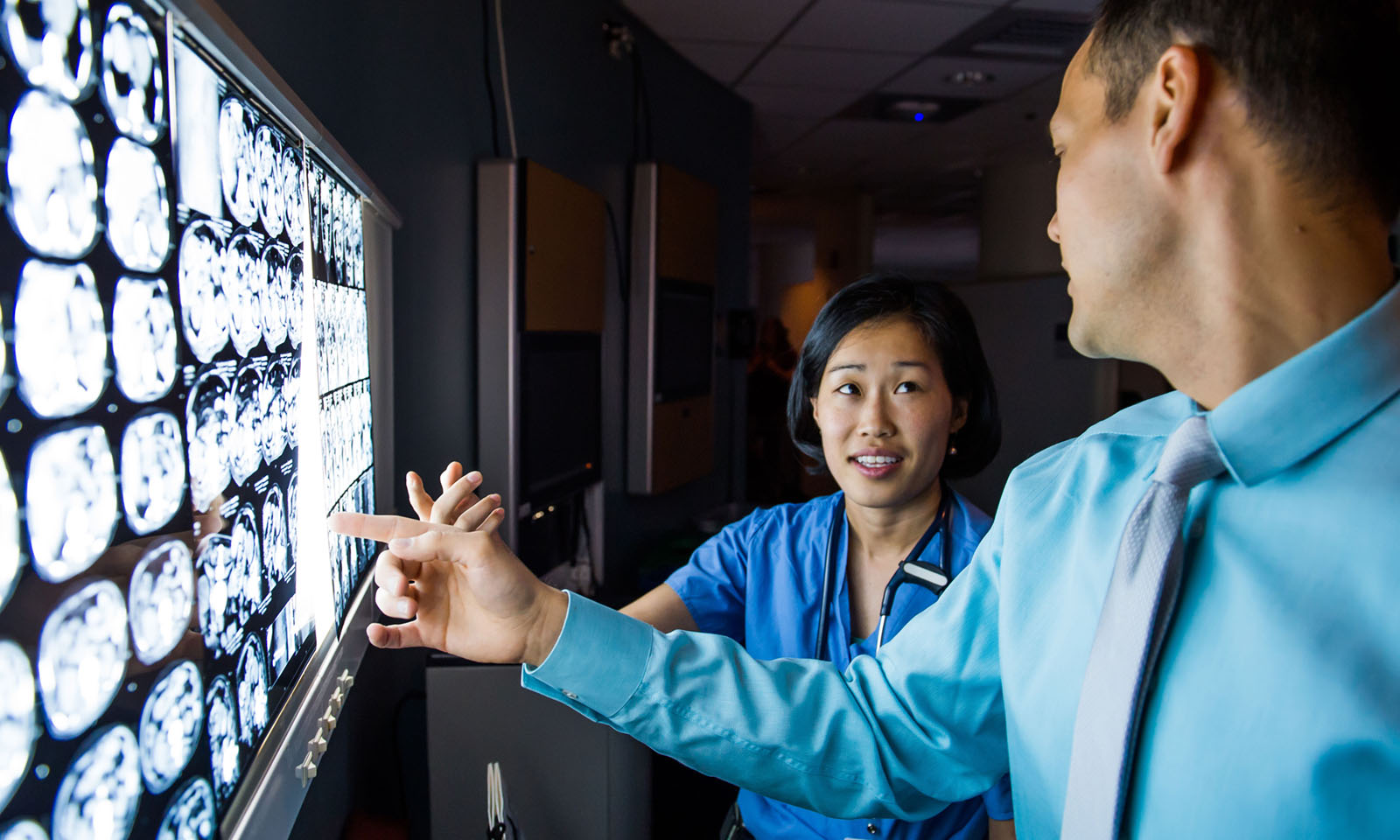 Physicians discussing patient image results. Physicians discussing patient image results.