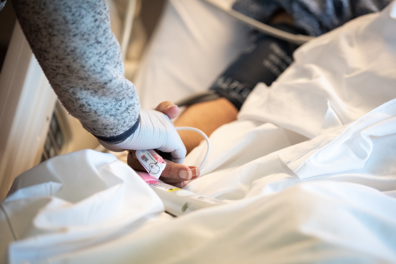 clincian holding hand of patient at bedside