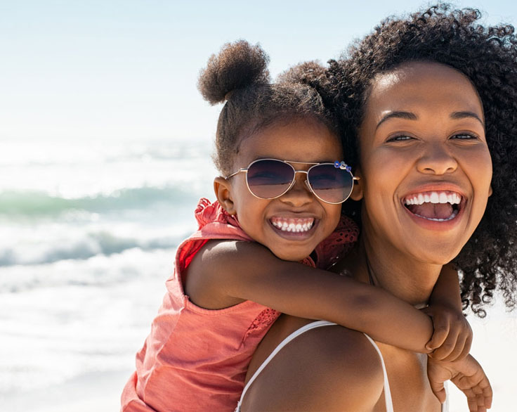 A mother with her daughter at the beach