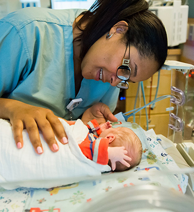 Mass General female nurse with pediatric patient