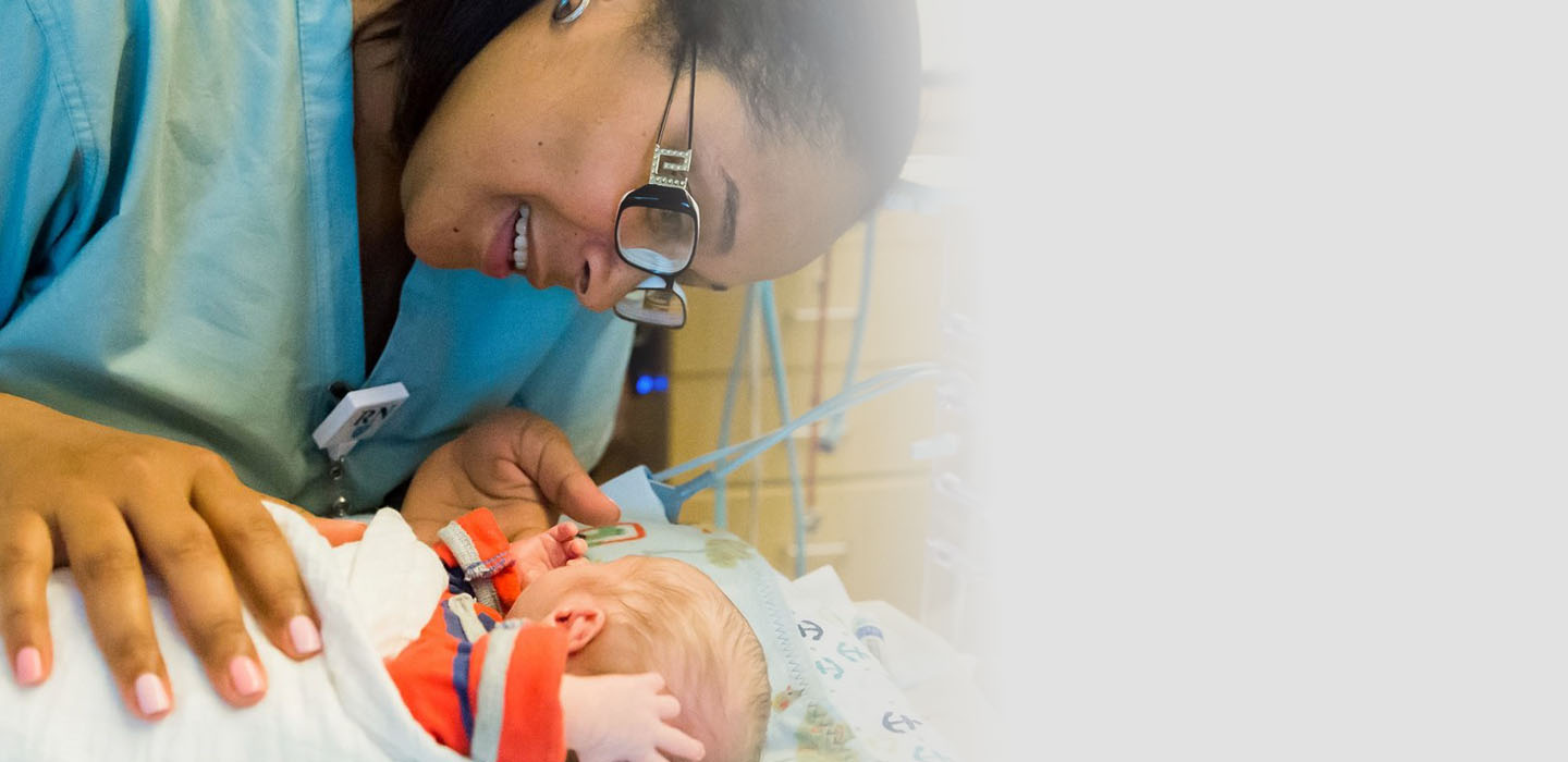 Mass General female nurse with pediatric patient