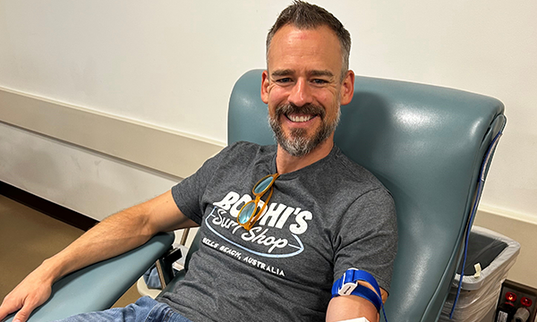 man donating blood in chair smiling man donating blood in chair smiling