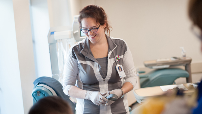 A technician smiles as she chats with a blood donor A technician smiles as she chats with a blood donor