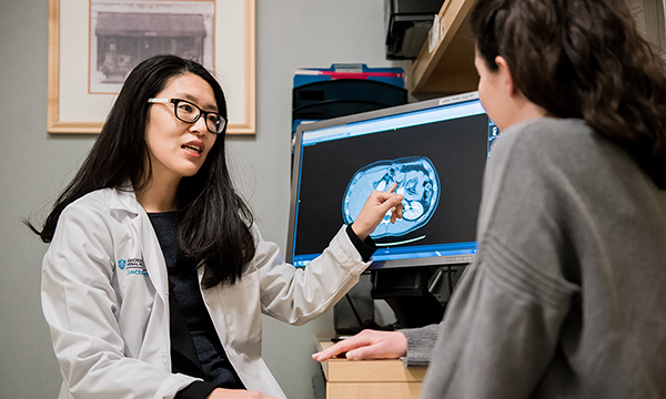 Dr. Jennifer Wo meeting with patient. Dr. Jennifer Wo meeting with patient.