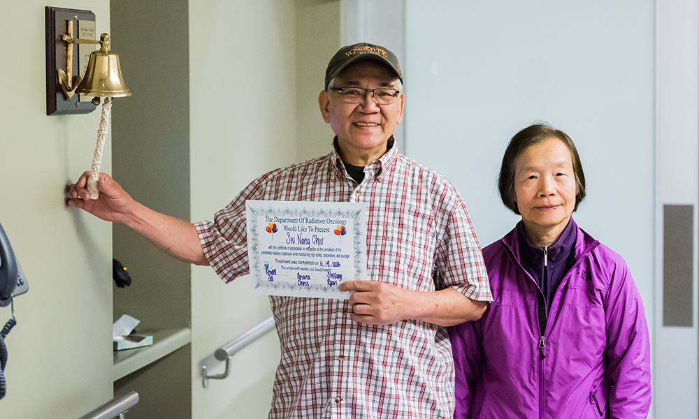 Patient and wife with the radiation oncology bell. Patient and wife with the radiation oncology bell.
