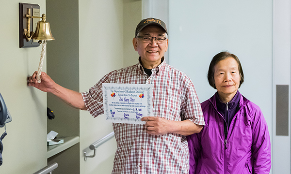 Patient and wife with the radiation oncology bell. Patient and wife with the radiation oncology bell.