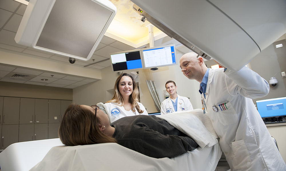 Radiation therapists with a patient during treatment. Radiation therapists with a patient during treatment.
