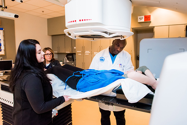 Radiation therapists with patient.