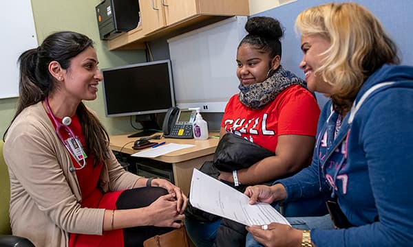 Dr. Sonali Malhotra consulting with a patient family. Dr. Sonali Malhotra consulting with a patient family.