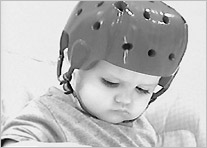 A toddler wearing a helmet.