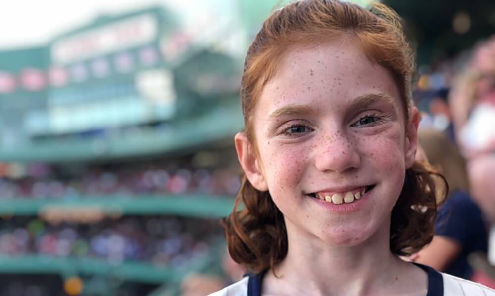 A red-headed girl of 10 or 12 smiles in the stands at Fenway Park. A red-headed girl of 10 or 12 smiles in the stands at Fenway Park.