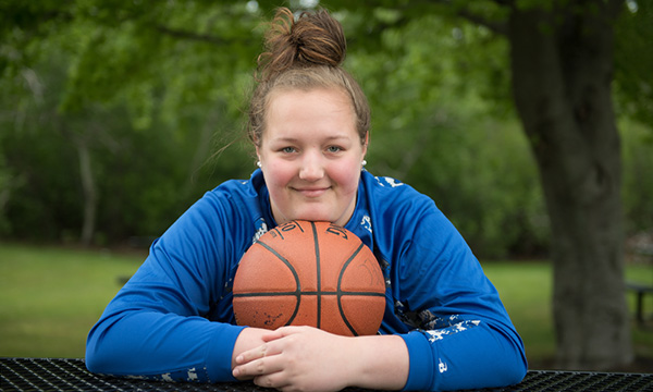 A Pediatric Urology patient poses with a basketball. A Pediatric Urology patient poses with a basketball.