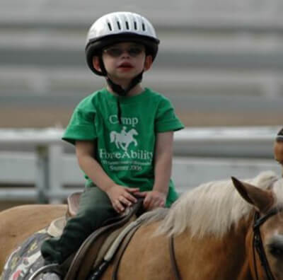 A pediatric Williams Syndrome patient riding a horse