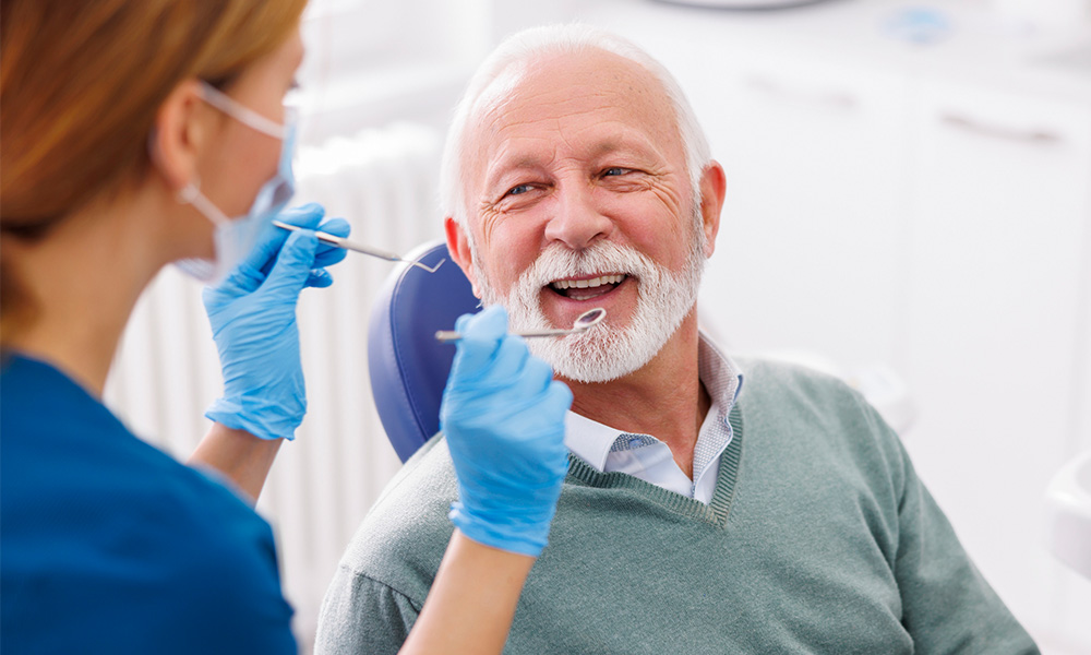 Female provider about to examine a patient's mouth Female provider about to examine a patient's mouth