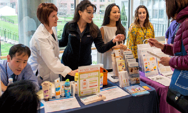 Dermatologists and staff educating people on how to protect their skin for the sun's damaging rays. Dermatologists and staff educating people on how to protect their skin for the sun's damaging rays.