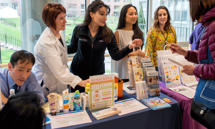 Dermatologists and staff educating people on how to protect their skin for the sun's damaging rays. Dermatologists and staff educating people on how to protect their skin for the sun's damaging rays.