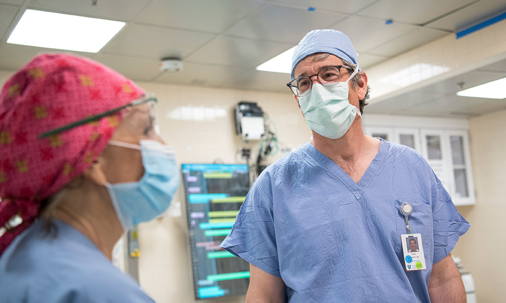 A masked weight center doctor consults with a colleague also in a mask A masked weight center doctor consults with a colleague also in a mask