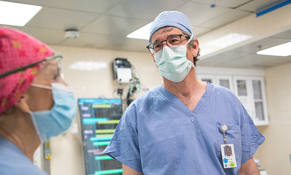 A masked weight center doctor consults with a colleague also in a mask A masked weight center doctor consults with a colleague also in a mask