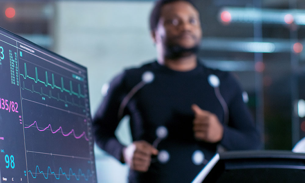 man running on treadmill while undergoing an EKG test man running on treadmill while undergoing an EKG test